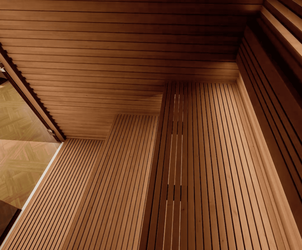 Inside an Auroom Nativa indoor sauna kit with benches, walls, and floors made of thermally modified aspen or thermo-aspen.